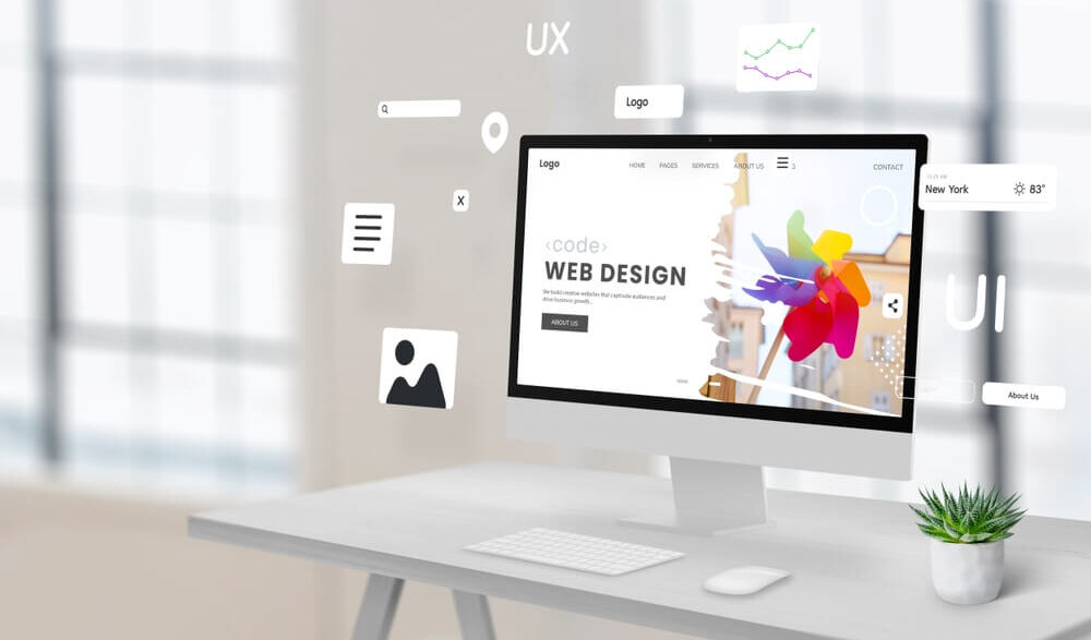 Business website open on a laptop and phone in a Liverpool workplace.