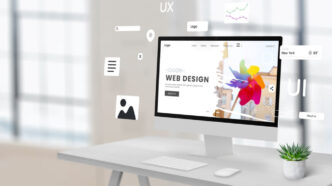 Business website open on a laptop and phone in a Liverpool workplace.