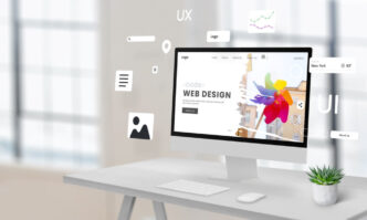 Business website open on a laptop and phone in a Liverpool workplace.